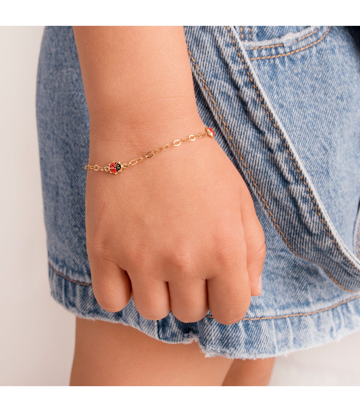 Pulsera mariquita para niña. Oro 18 kilates. Joyas infantiles.