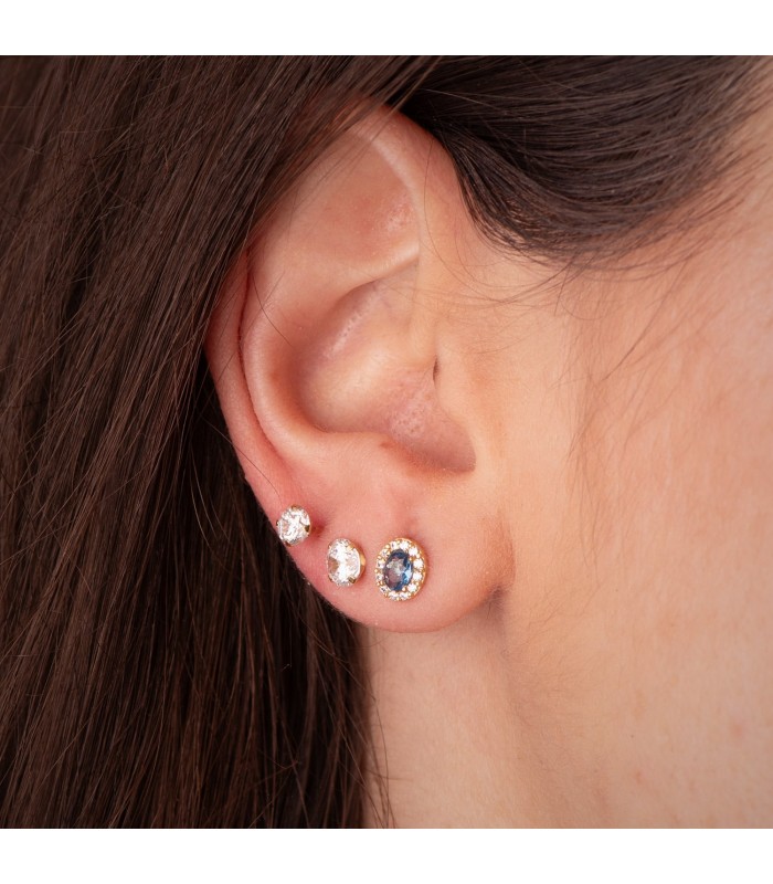 Orecchini da donna con topazio azzurro 18kt. Piercings all'orecchio in oro 18 carati.